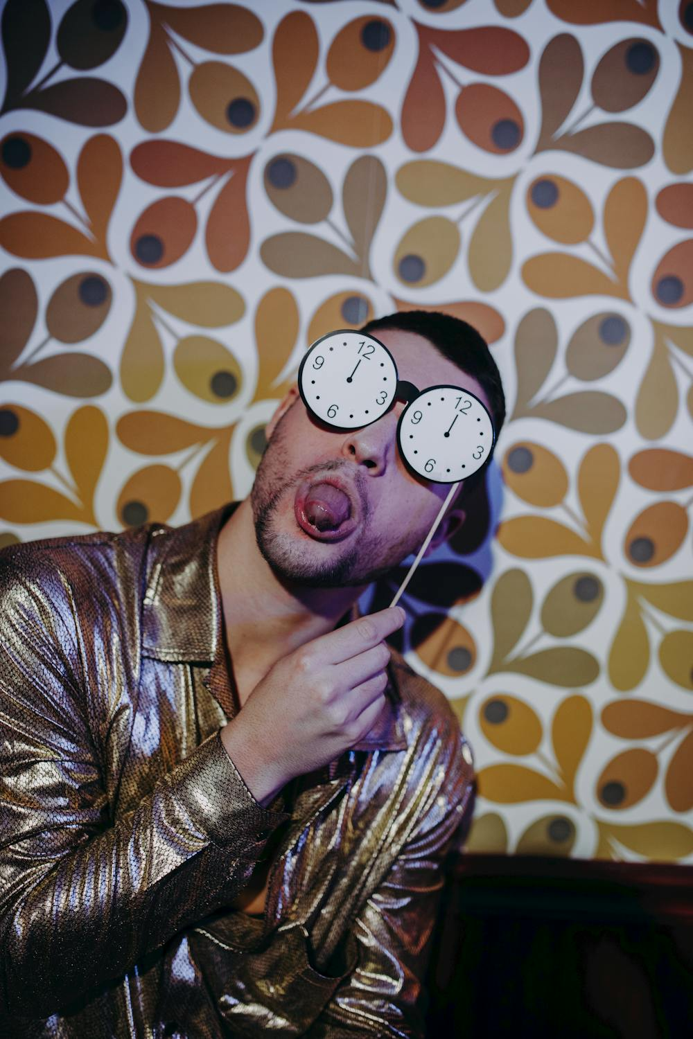 Man Sticking His Tongue Out While Holding Clock Sunglasses