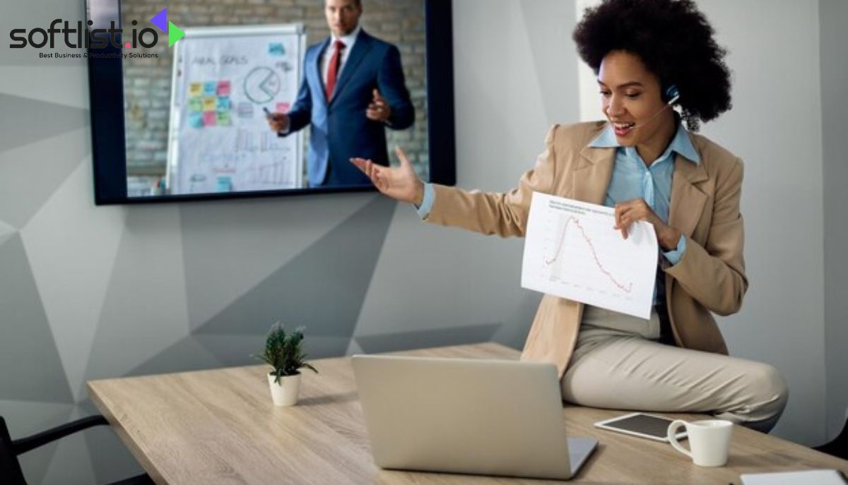 A woman is utilizing VoIP technology as she sits in front of a laptop, operating a screen for modern business purposes.