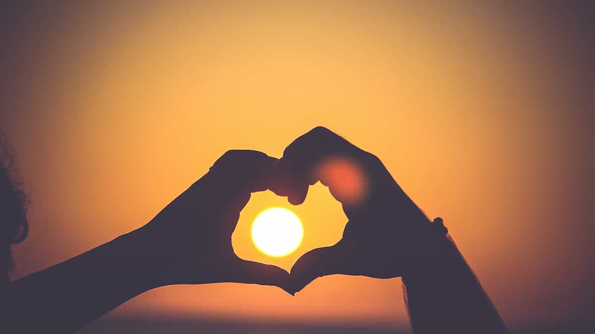 silhouette of person's hands forming heart