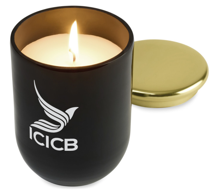 Screenshot of a lit candle in a black candle holder. 