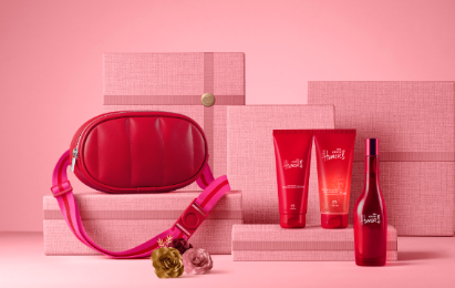 A group of pink boxes with a bag and bottles of cosmetics

Description automatically generated