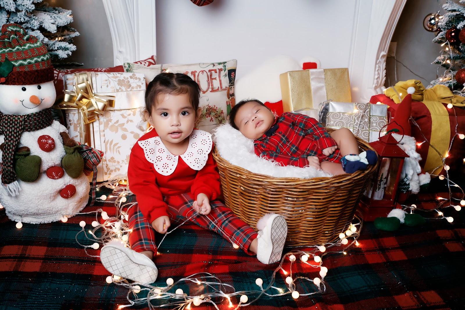 newborn christmas photo idea: newborn sleeping in a wicker or Christmas basket dressed up in Christmas-themed outfit