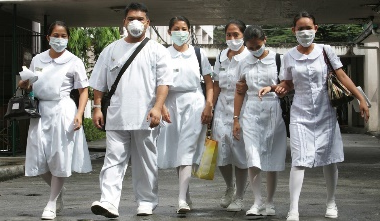 A group of people wearing white uniforms and masks

Description automatically generated