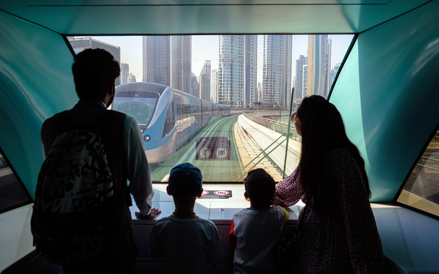 Children with their parents travelling in Dubai Metro
