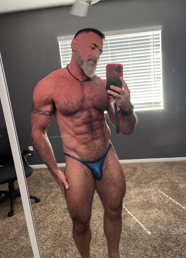 Lawson James taking an iphone mirror selfie wearing a tiny shiny g string thong