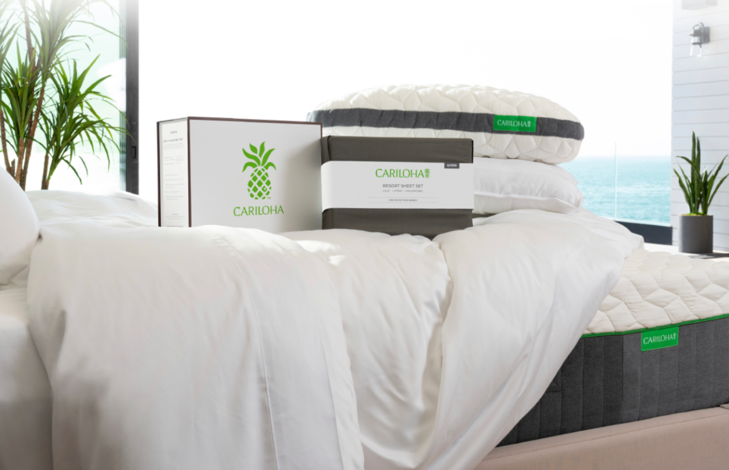 A bed with white sheets and boxes on top of it

Description automatically generated
