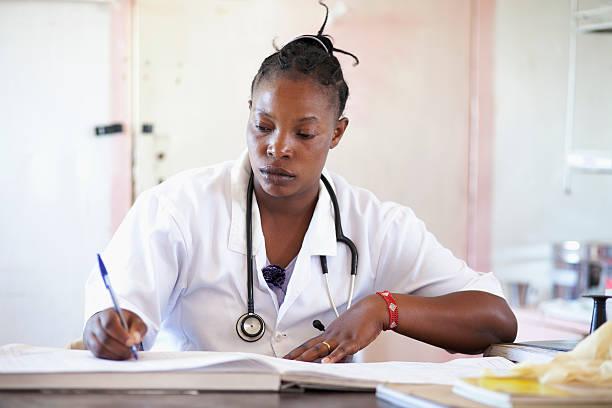 african female doctor in her office - doctor kenya stock pictures, royalty-free photos & images