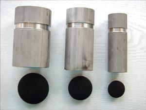 Several metal cylinders with round black circles

Description automatically generated