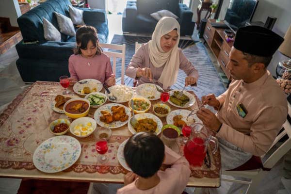 Muslim family gathering and eating together during Eid-Fitr Celebration