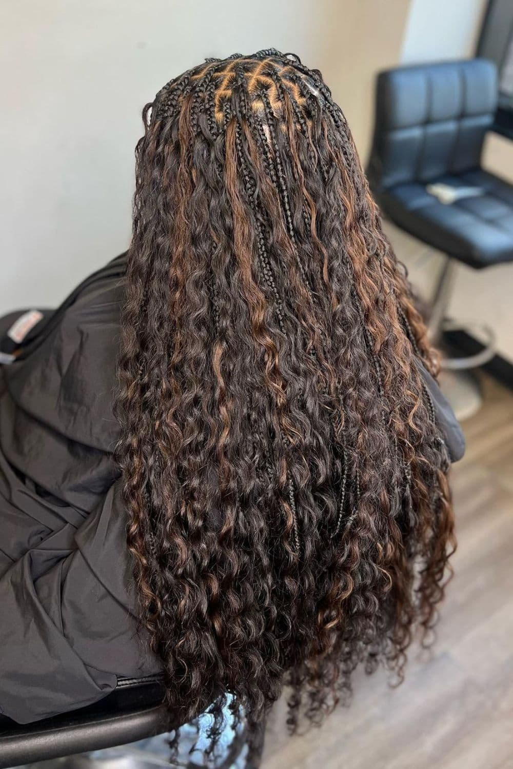 Back view of a lady wearing the Black and Brown Goddess Braids