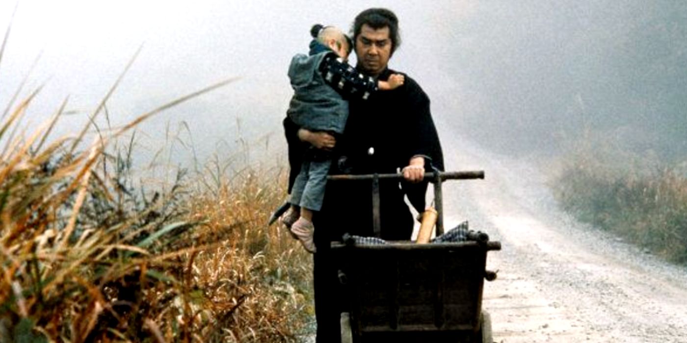 Tomisaburo Wakayama as Ogami Ittō carrying Akihiro Tomikawa as Ogami Daigoro on the road in Lone Wolf and Cub: Sword of Vengeance (1972)