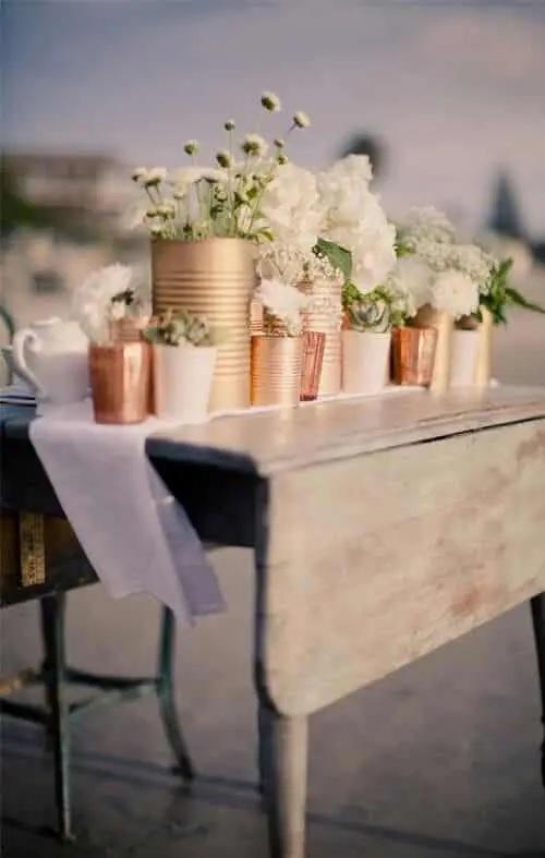 Upcycled tin-can centerpieces and wine-bottle table numbers.