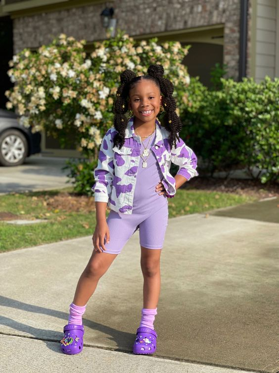 Picture showing a little girl rocking the footwear in  her all purple outfit