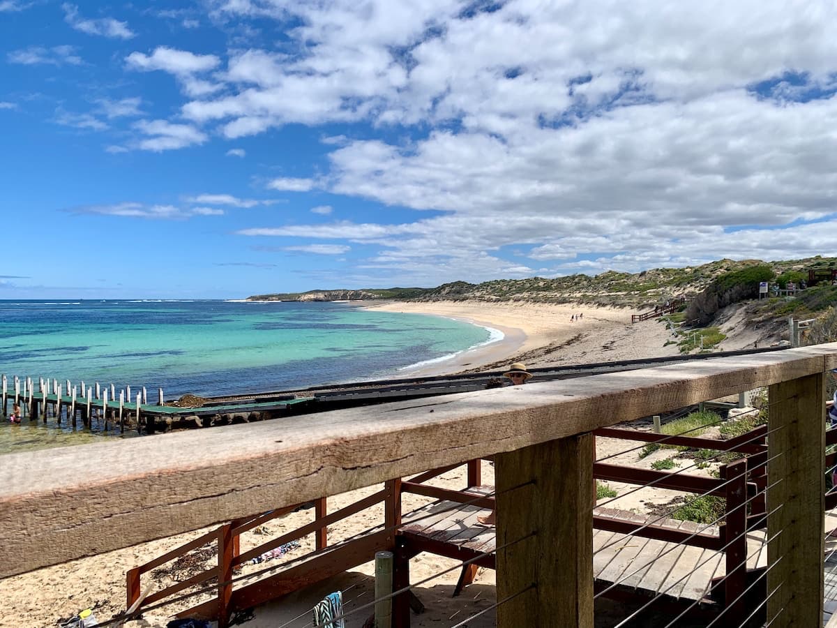 Boardwalk down to a beach in Margaret River with bright blue water