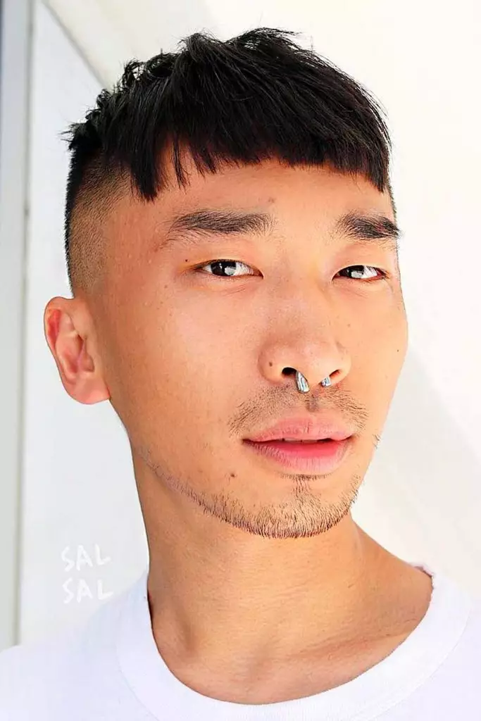 Close up view of a guy rocking a popular korean haircut, the short sides with bang