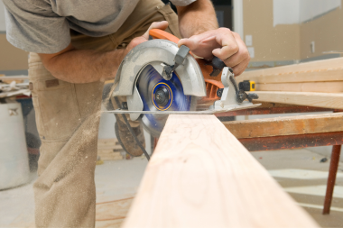 top questions your remodeling contractor should ask you carpenter sawing wood board custom built michigan