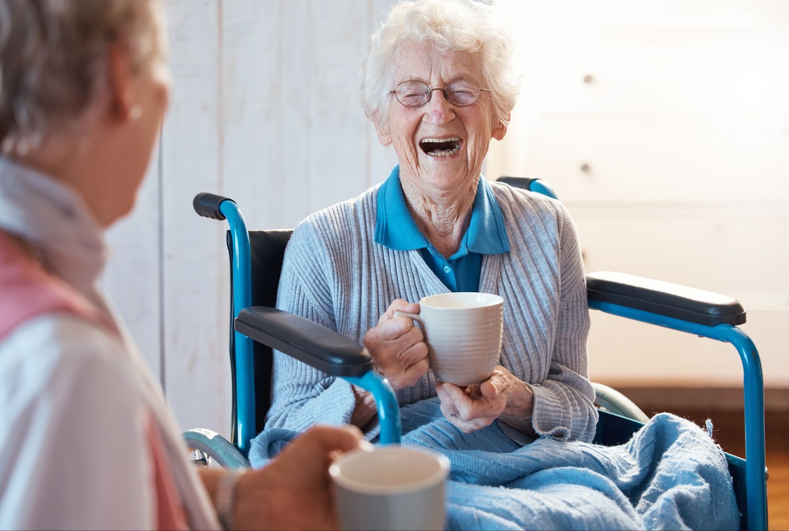 two senior ladies enjoy tea and smiling
