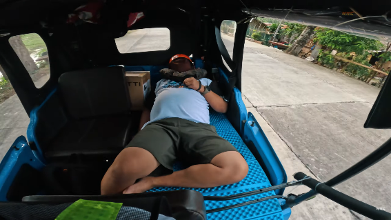 A person sleeping in a vehicle

Description automatically generated