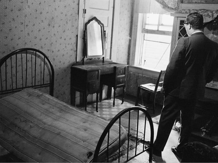 A news reporter stands in the room rented by the assassin who shot Dr. Martin Luther King Jr., in Memphis, Tenn., April 5, 1968.