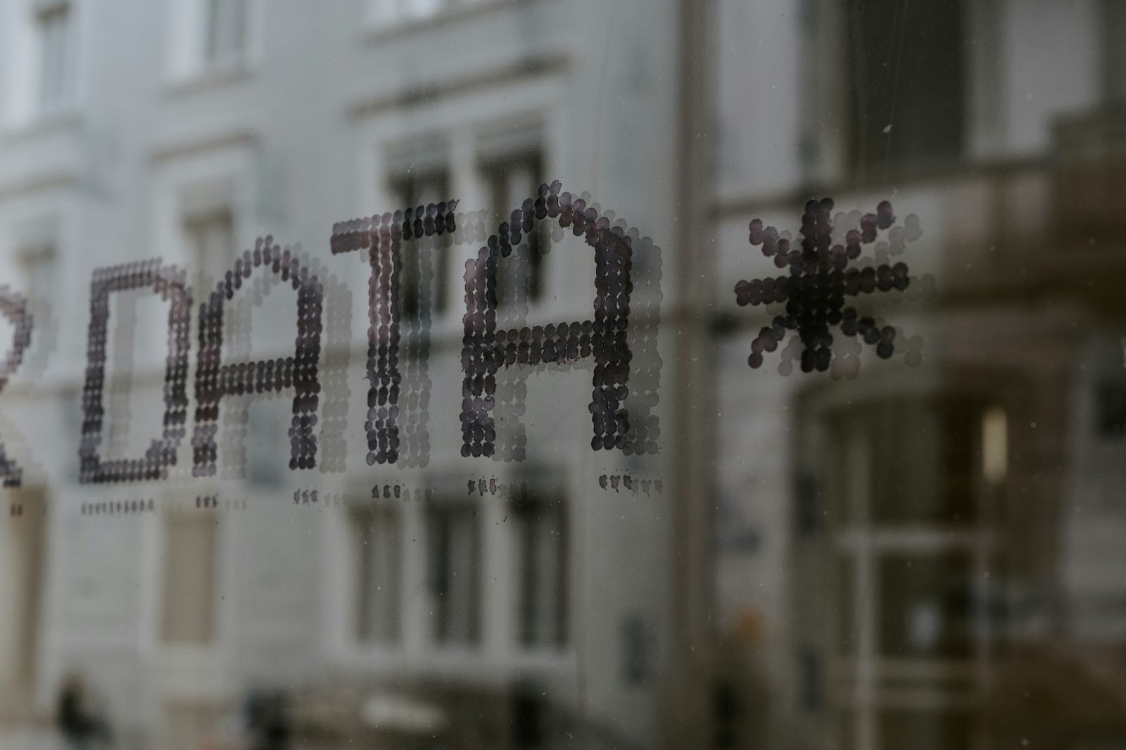 The word 'DATA' spelled out on a foggy window, symbolizing the concept of data transparency and privacy concerns related to data theft