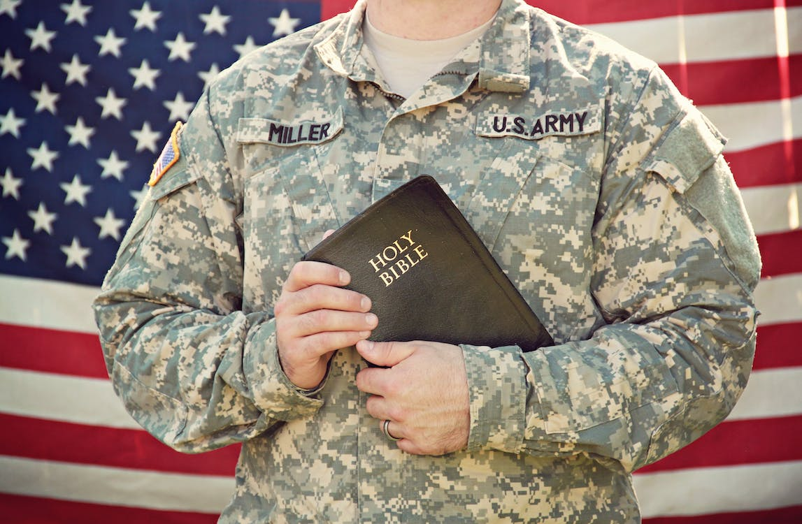 U.S. Army Soldier is Holding Holy Bible in His Hands
