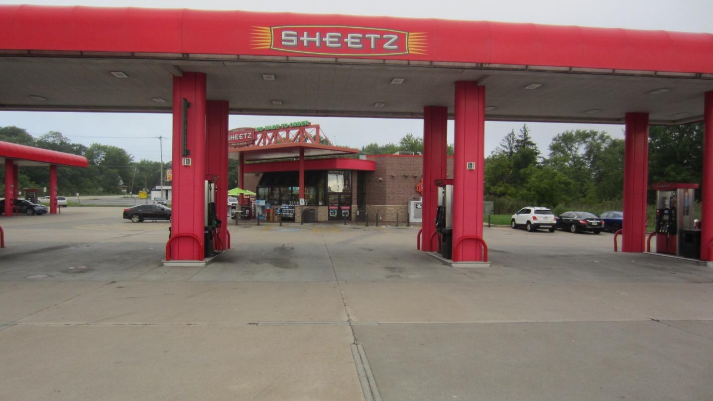 A gas station with red pillars

Description automatically generated