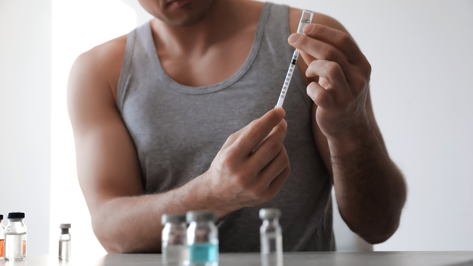 A photo of someone putting drugs into a needle. 