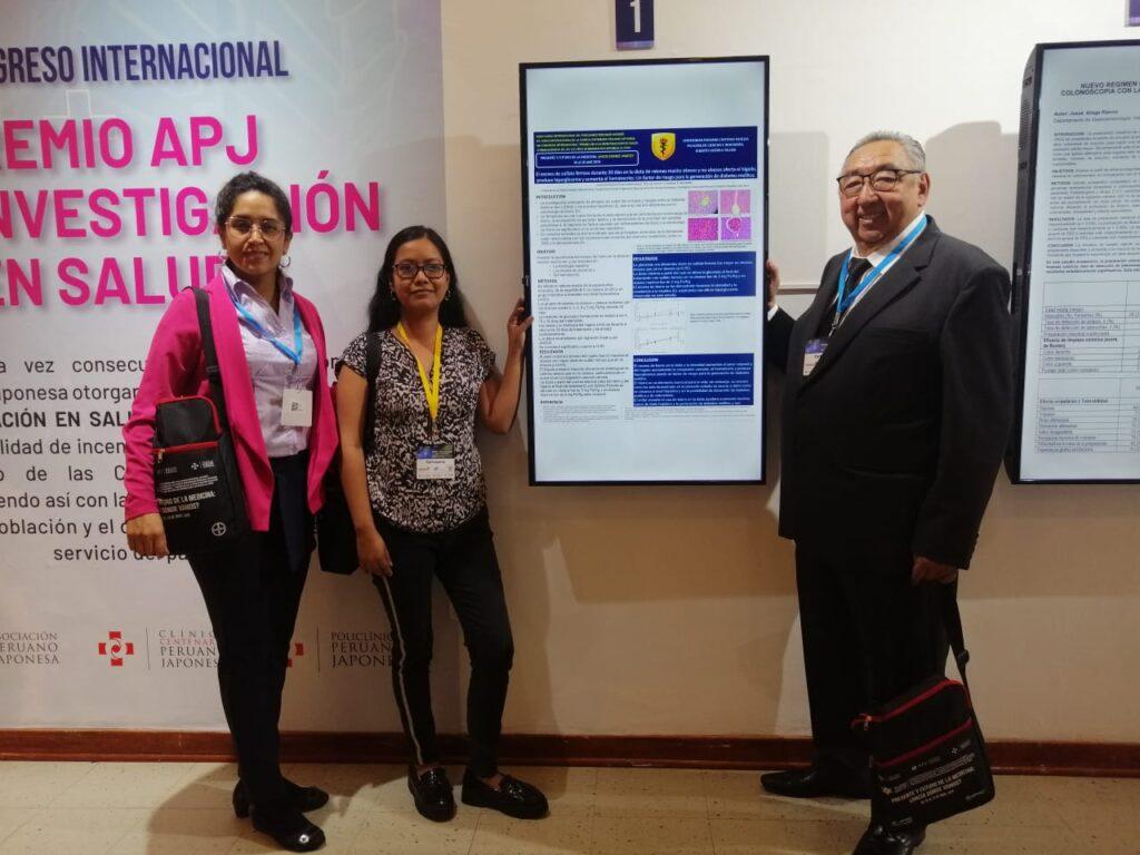 A group of people standing next to a white board

Description automatically generated