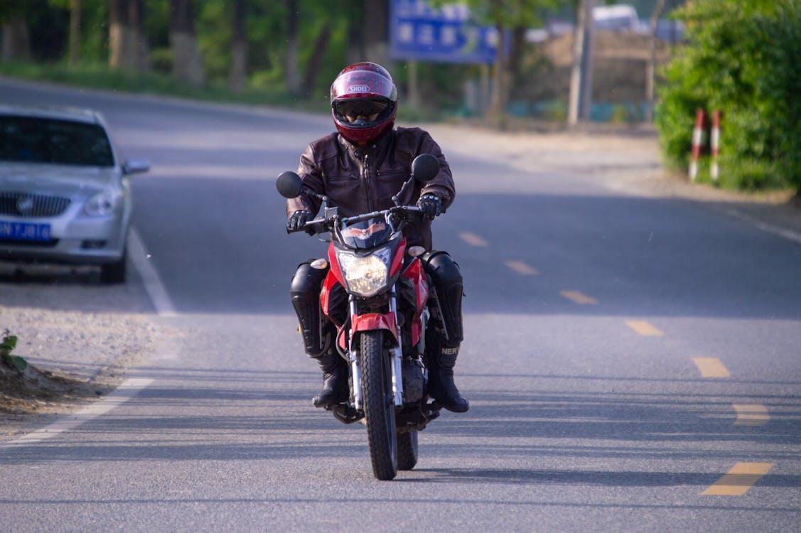 Free Man Riding a Motorcycle on the Street  Stock Photo