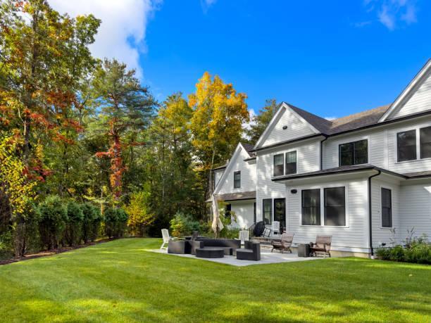 Summer is over in the garden Patio cushions are put away and the table is sideways to drain water - summer in the suburban garden is history for this year and the leaves are getting colorful houses stock pictures, royalty-free photos & images