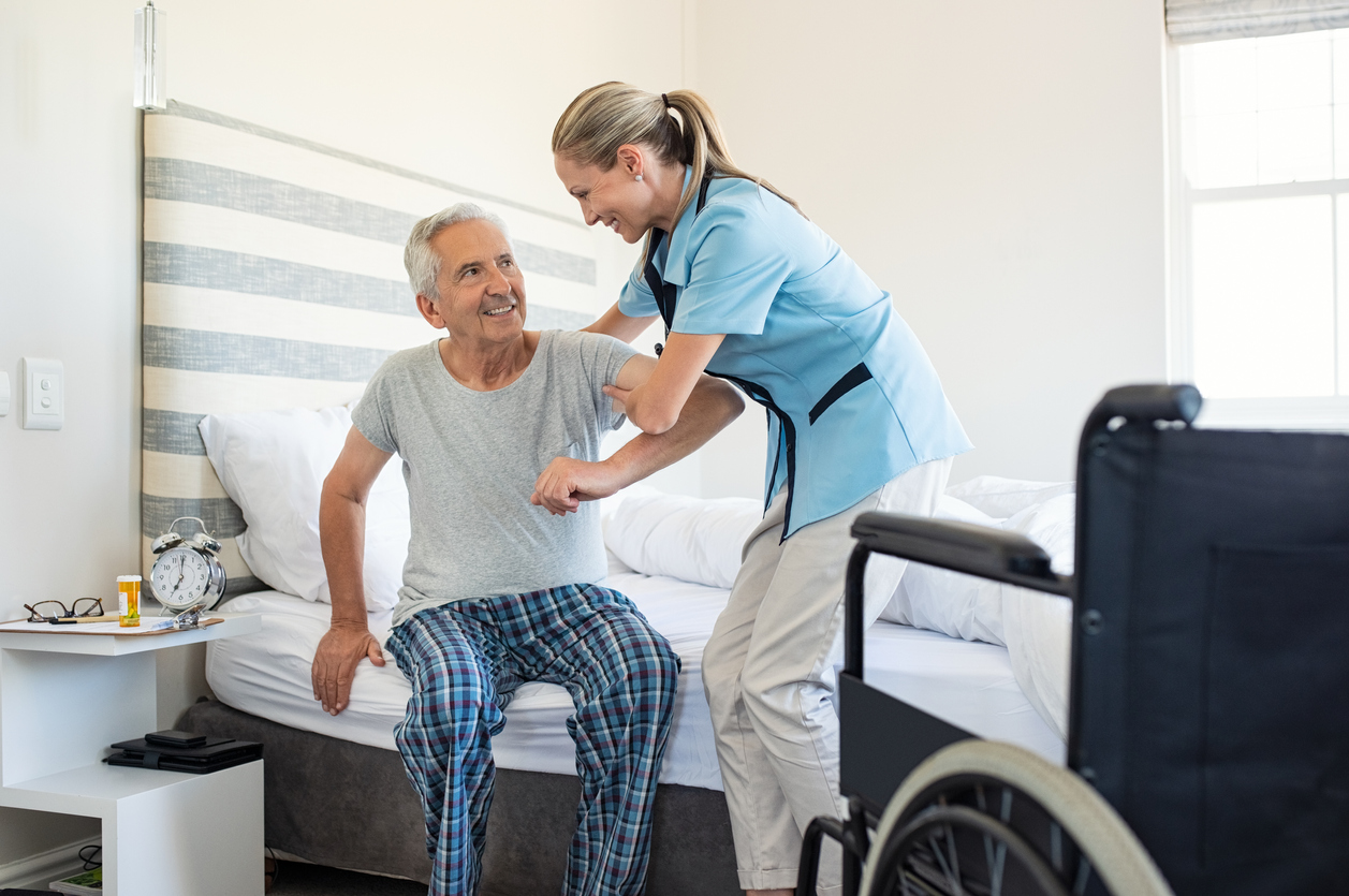 Senior being held out of bed
