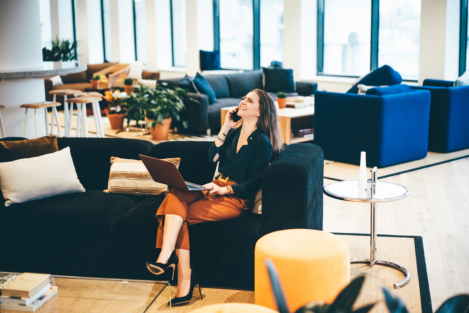 Happy businesswoman talking on the phone in a modern office about the future of IT.