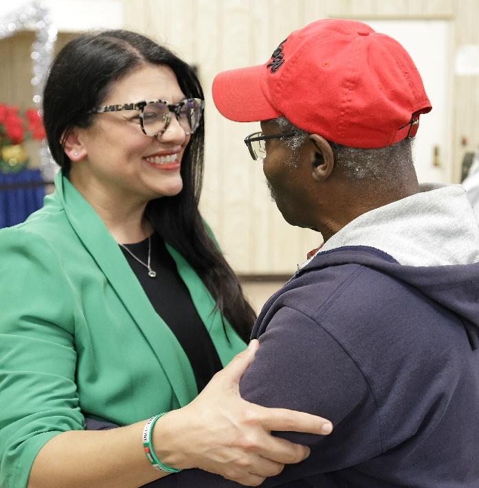 Rashida greeting a supporter