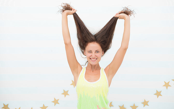 happy woman holding her hair