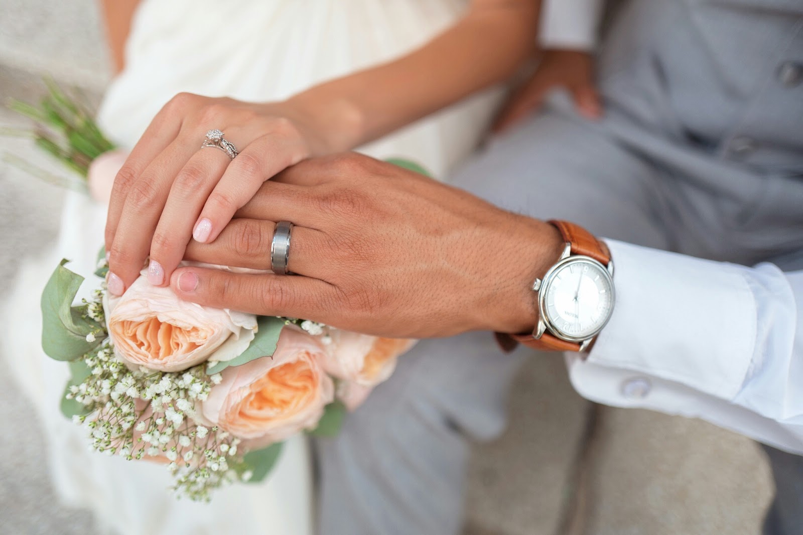 A couple showing off wedding rings during a symbolic ceremony. 