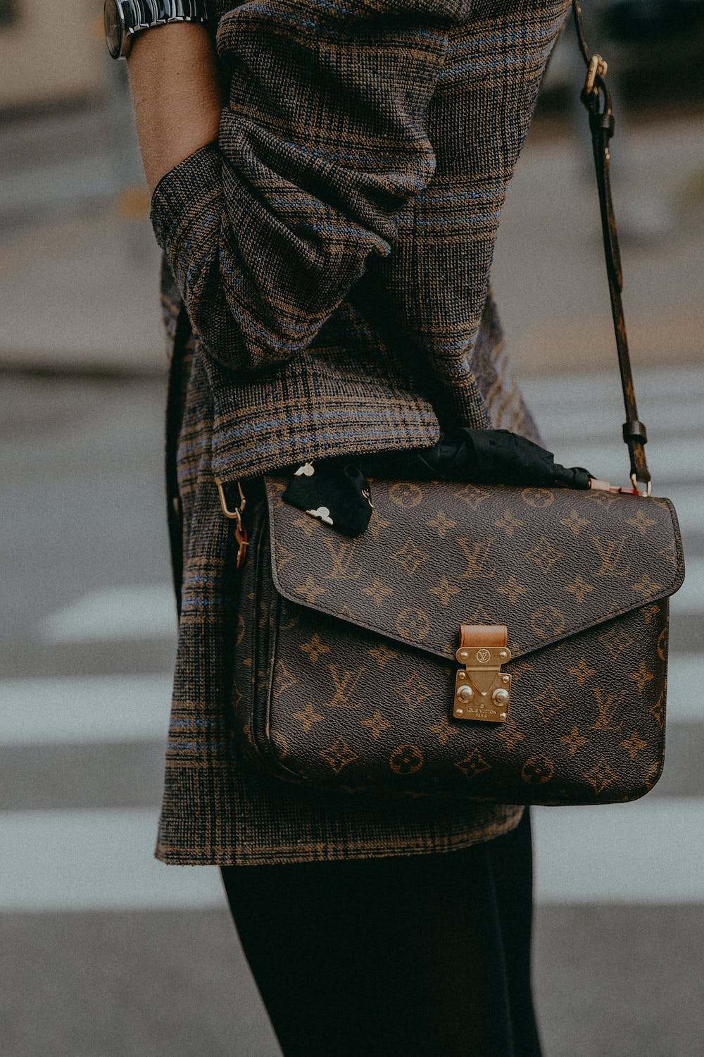 A woman carrying her Louis Vuitton bag.