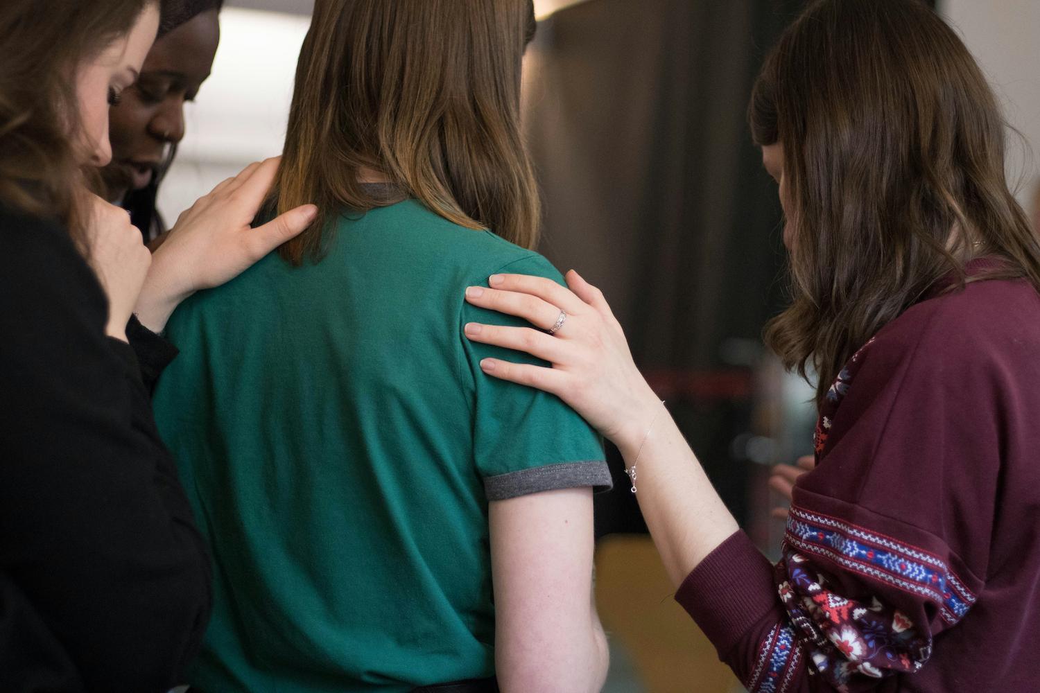 A group of Christian youth women, praying together.