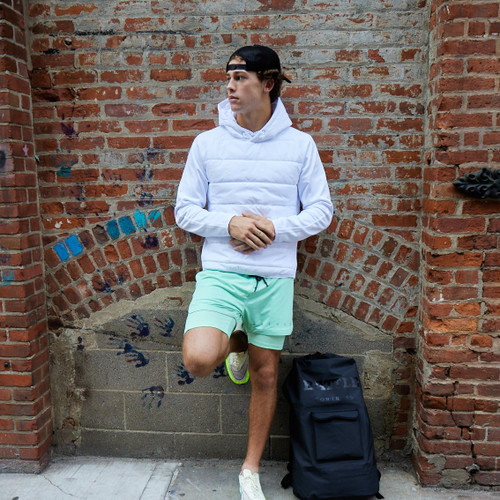 Male wearing mint green Battle Fly 5 men's shorts with streetwear style 
