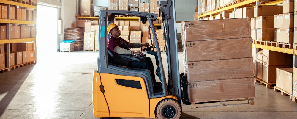 A self storage owner using a forklift and pallet to move their stuff into their unit