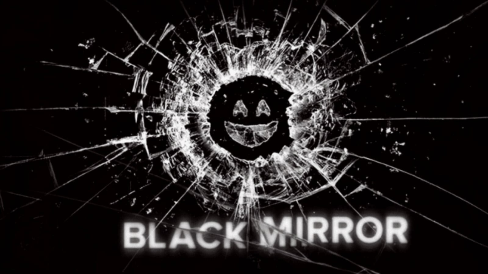 In the image, a rectangular glass surface is set against a dark backdrop. The glass is shattered, prominently broken at the center with fragments and cracks extending towards the margins. Within the central hole, forming a complete circle, three small glass pieces are arranged to create a smiling emoji. The word "Black Mirror" is inscribed in white beneath the image.