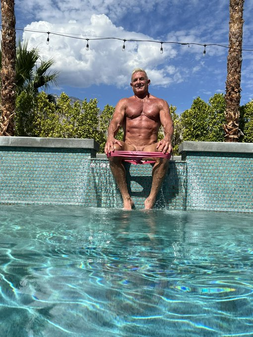 Matthew Figata outside at the pool naked in palm springs with his pulled down swim trunks hiding his exposed penis
