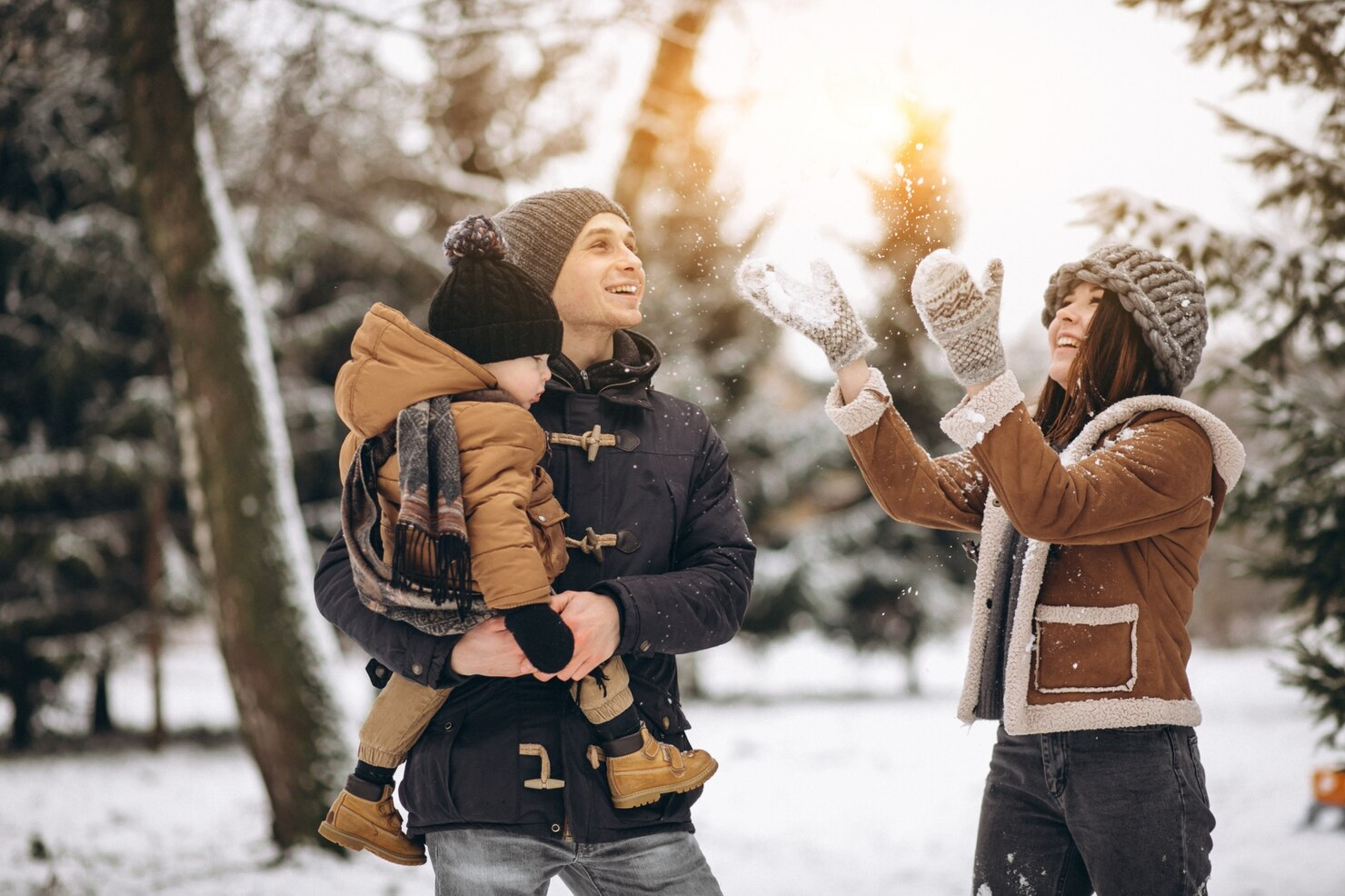 A family enjoying the snowfall together.