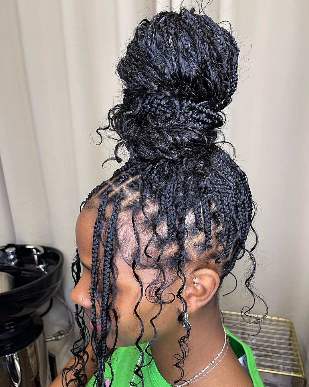 Picture of a lady rocking the top knot braids