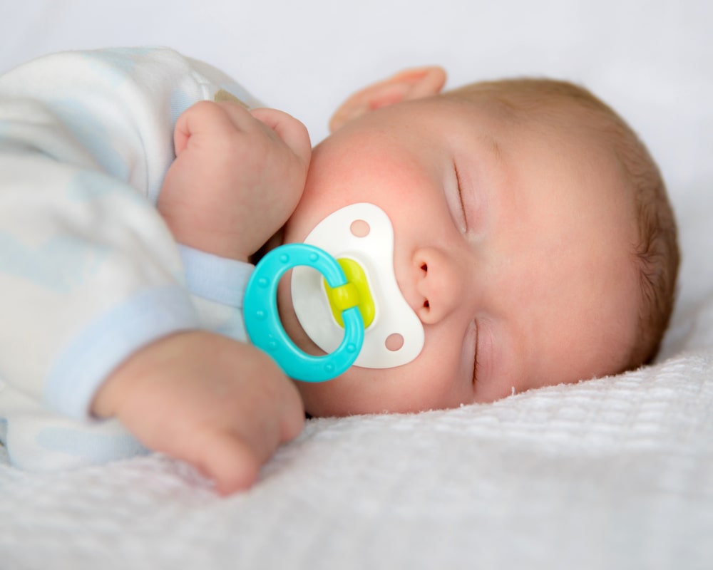 baby sleping with pacifier 