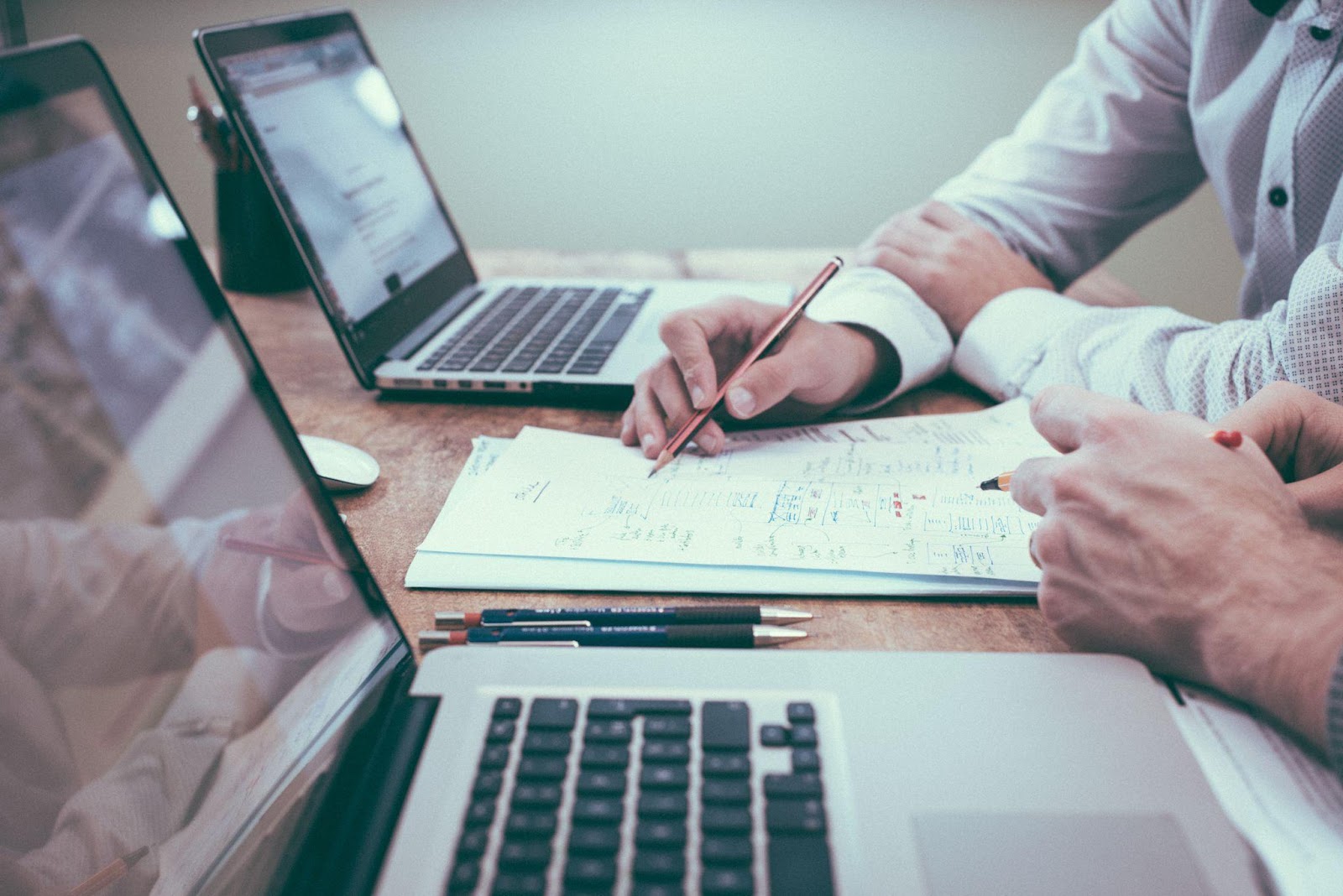 Accountants working together with laptops
