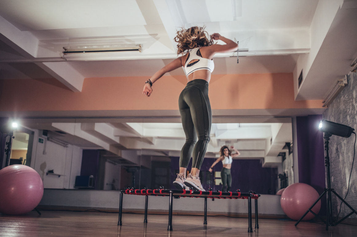 Woman fitness rebounding trampoline exercise