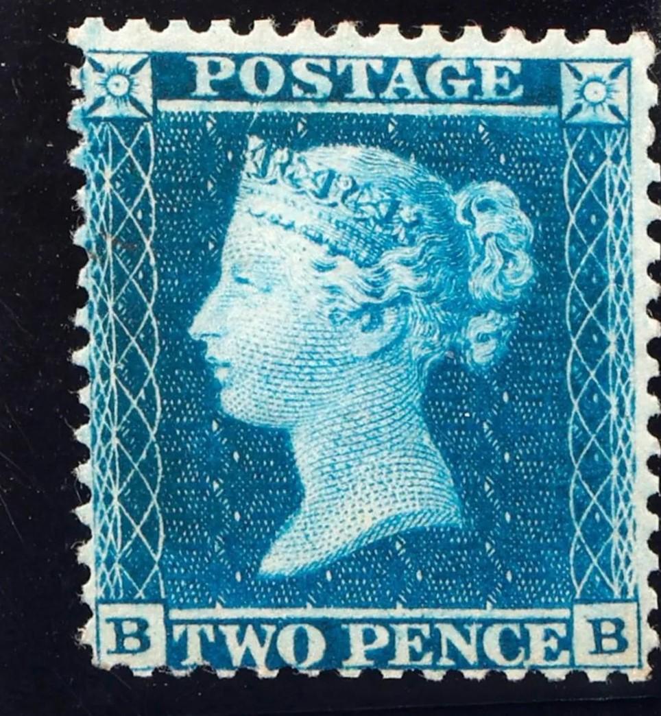 A blue postage stamp with a profile of a personDescription automatically generated