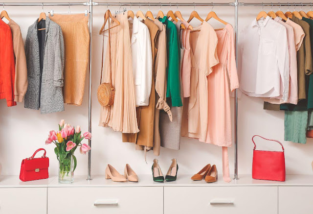 A closet with clothes and shoesDescription automatically generated