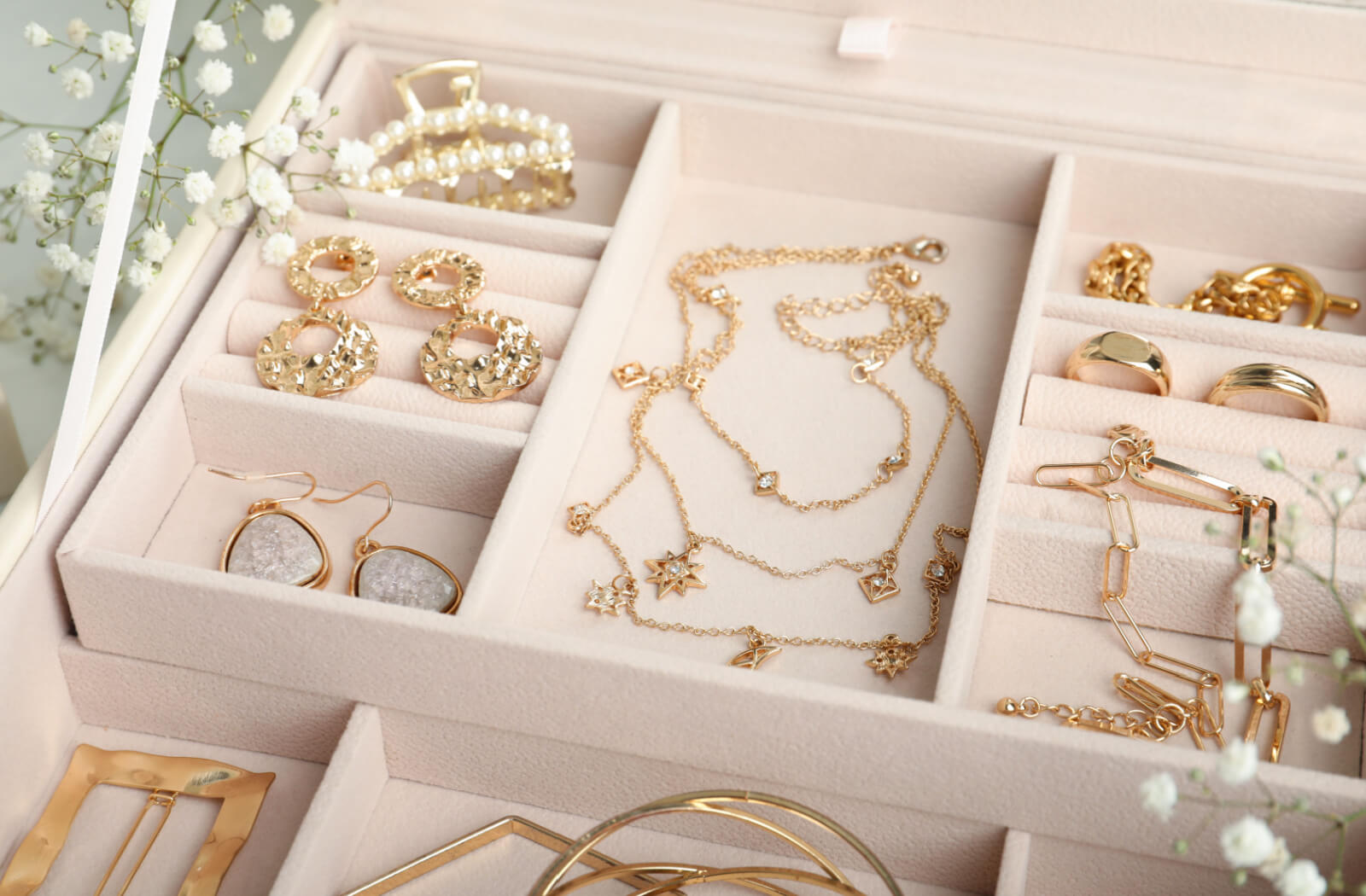 A collection of various jewelry including rings and necklaces in a jewelry box.