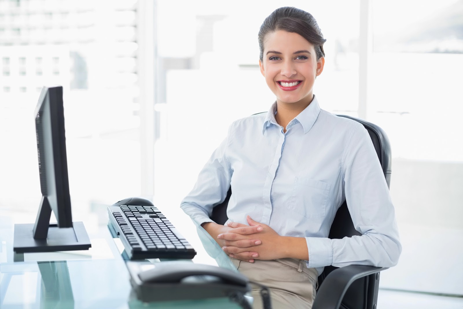 A women sitting comfortably in office on a swivel chair